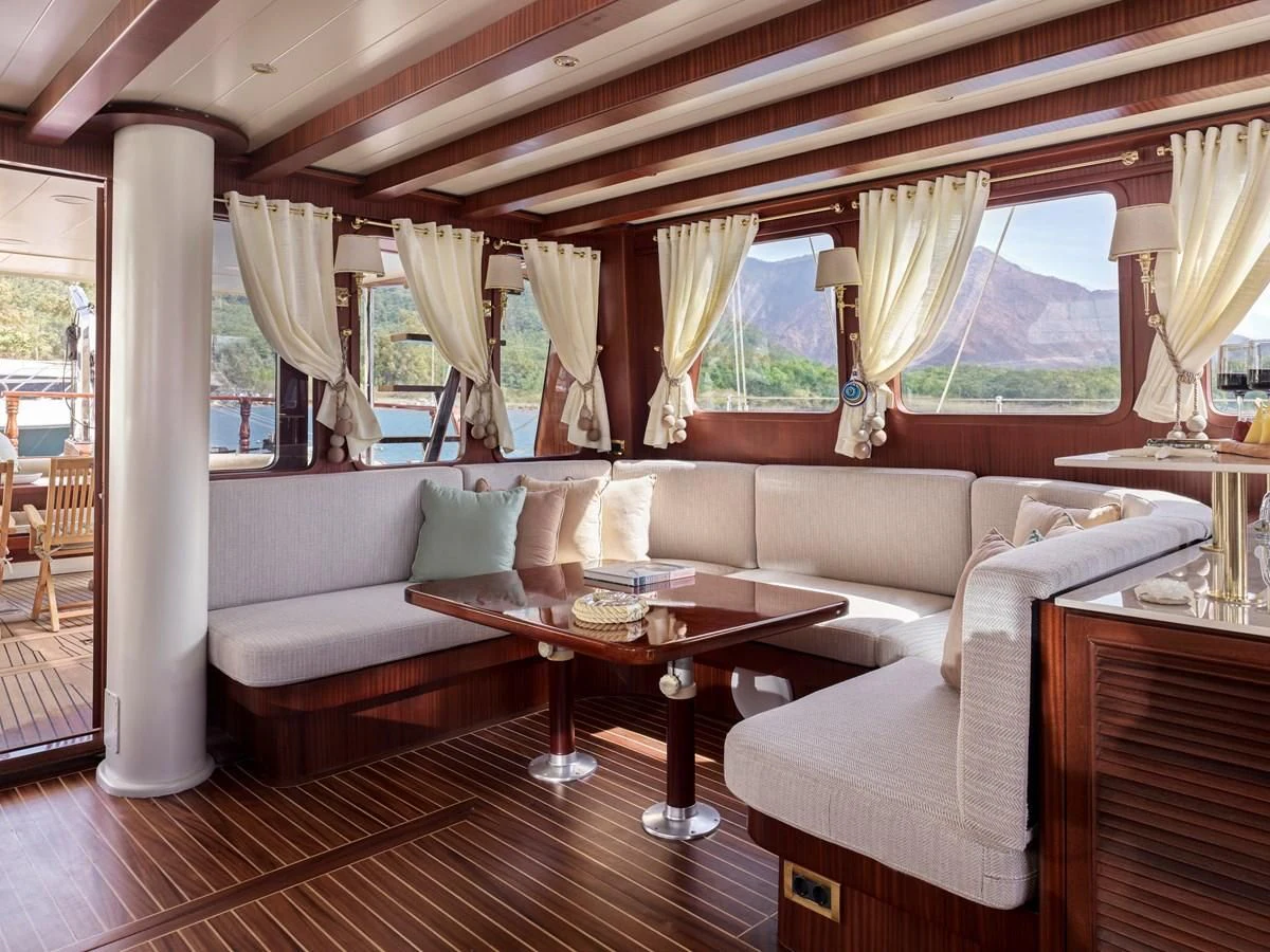a living room with a couch and a table aboard KAFTAN Yacht for Sale