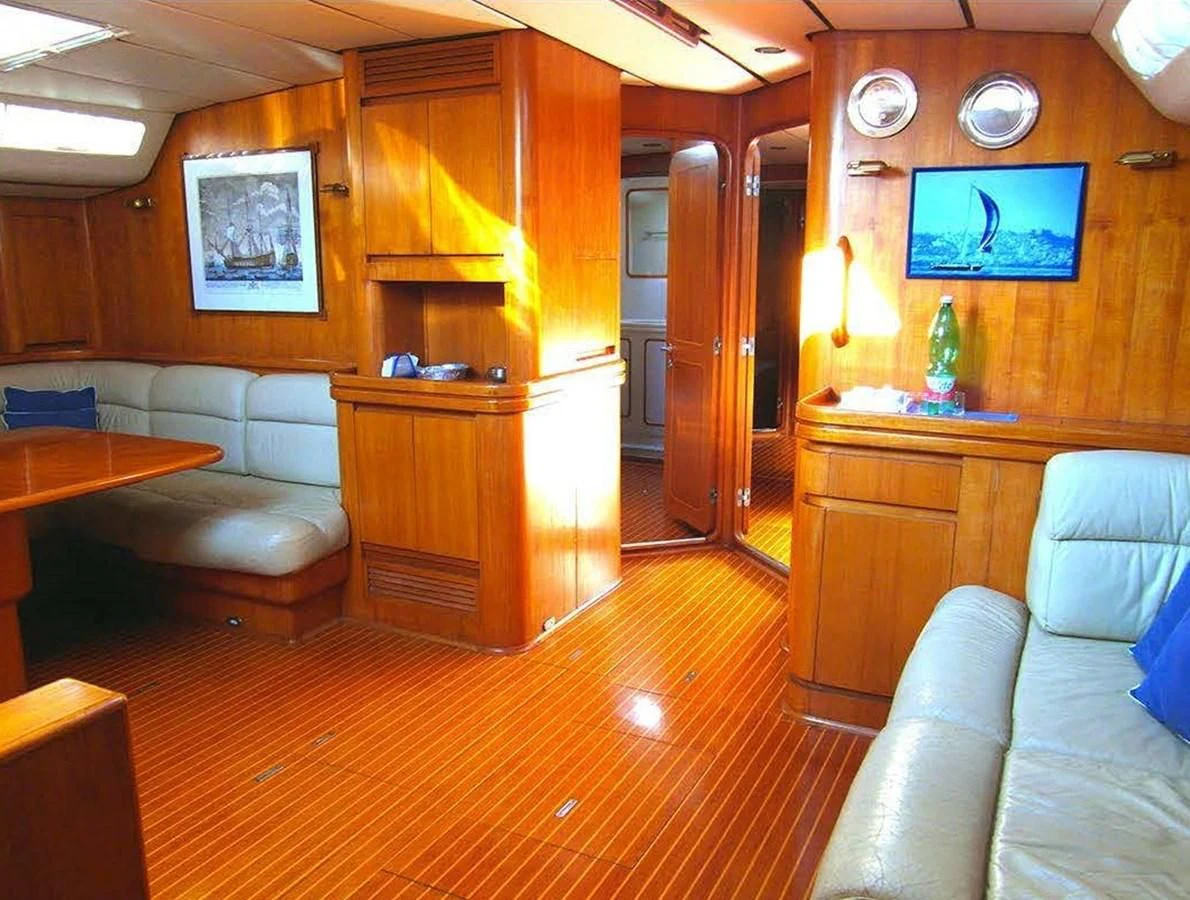a living room with a wood cabinet aboard BLUE WING Yacht for Sale