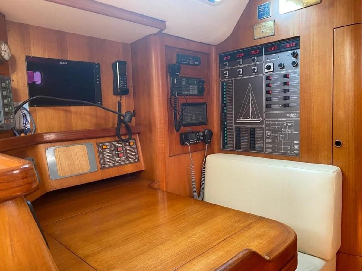 a room with a wood floor and a television on the wall aboard BLUE WING Yacht for Sale