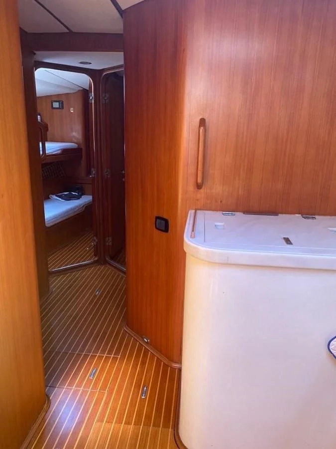 a room with a fridge and a door aboard BLUE WING Yacht for Sale