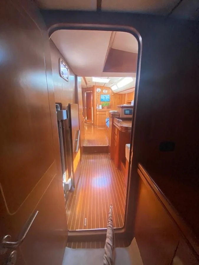 a hallway with a door and a window aboard BLUE WING Yacht for Sale