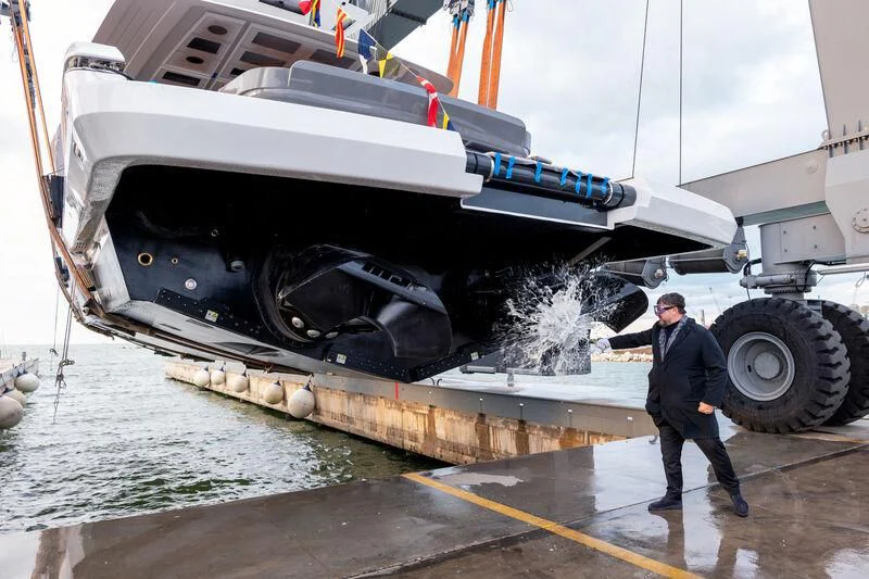 a man standing next to a boat aboard IL SOGNO Yacht for Sale