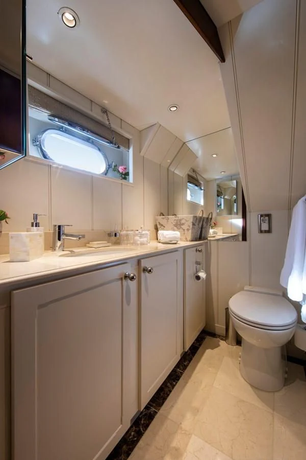 a bathroom with a toilet and a sink aboard ODYSSEY III Yacht for Sale