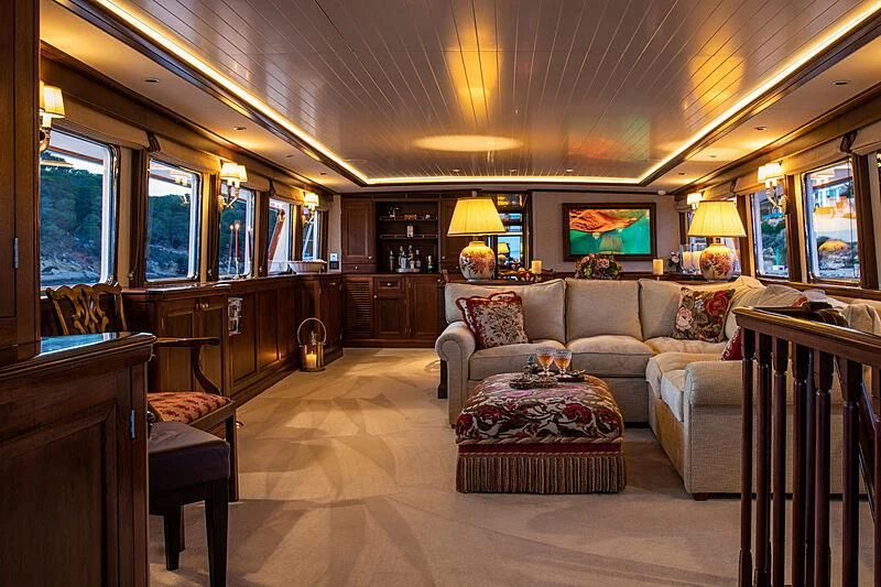 a living room with a couch and a table aboard ODYSSEY III Yacht for Sale