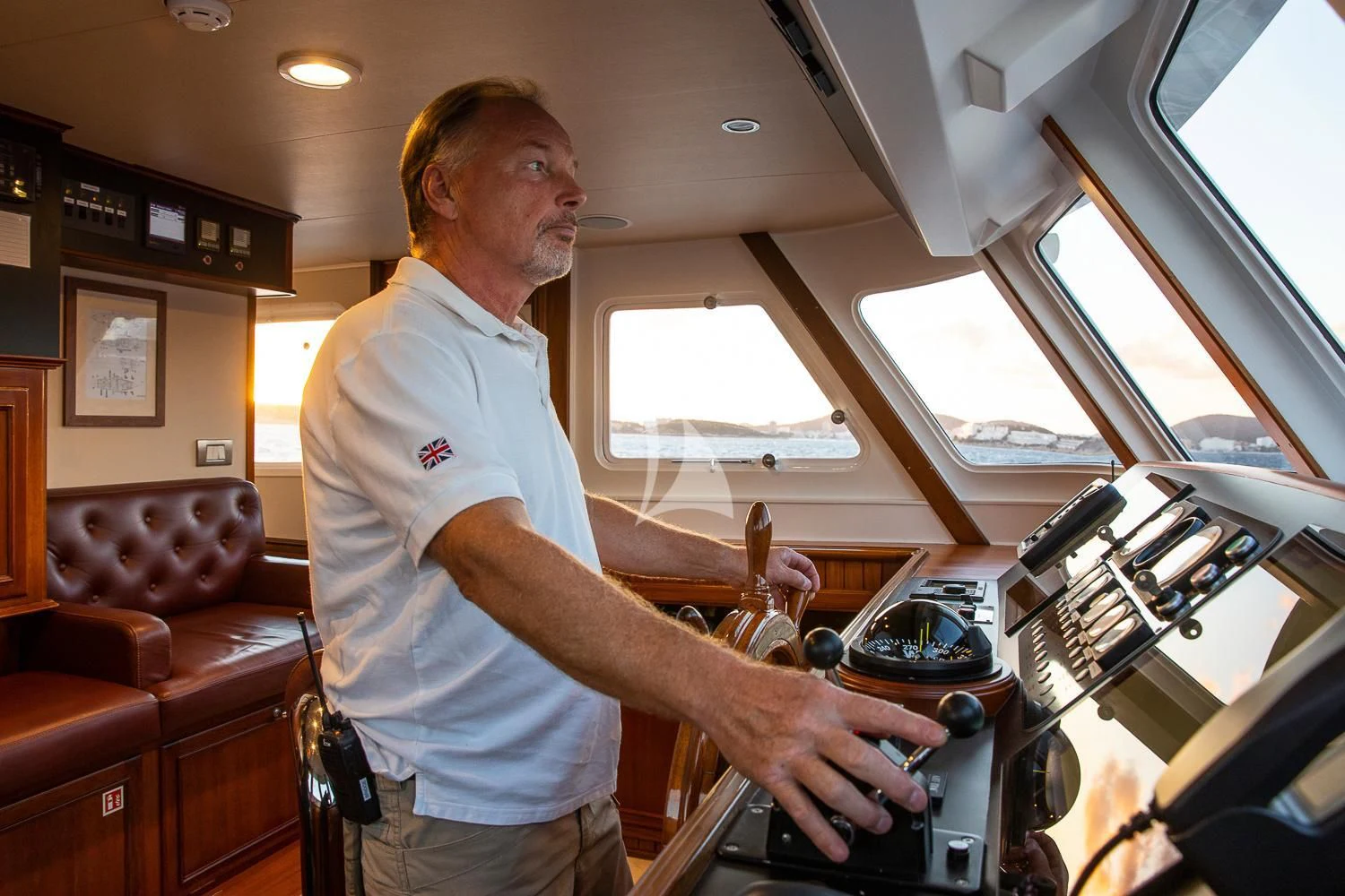 a man in a white shirt cooking in a kitchen aboard ODYSSEY III Yacht for Sale