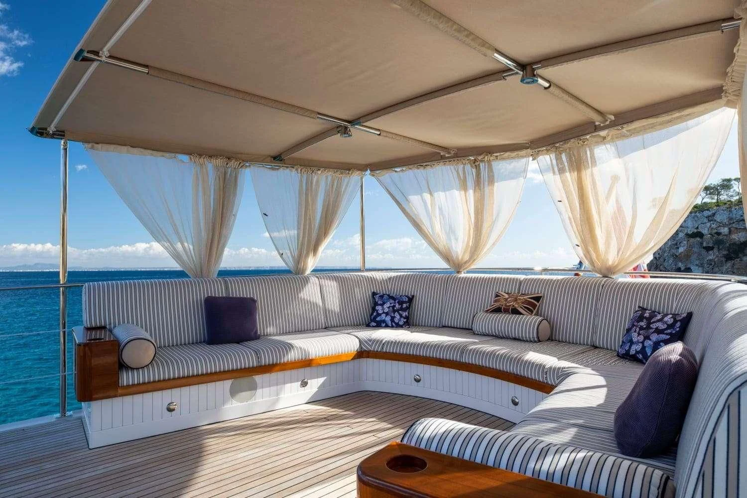 a large bed with a white canopy aboard ODYSSEY III Yacht for Sale
