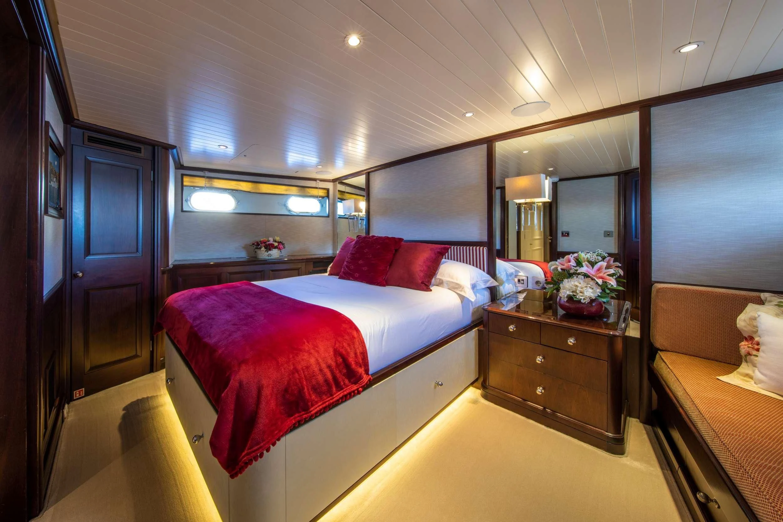 a bedroom with a bed and a desk aboard ODYSSEY III Yacht for Sale