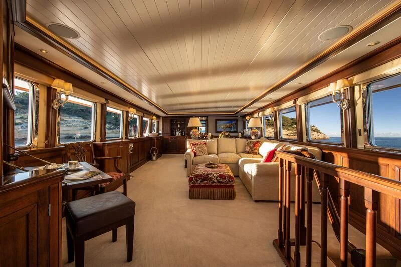 a living room with a couch and a table aboard ODYSSEY III Yacht for Sale