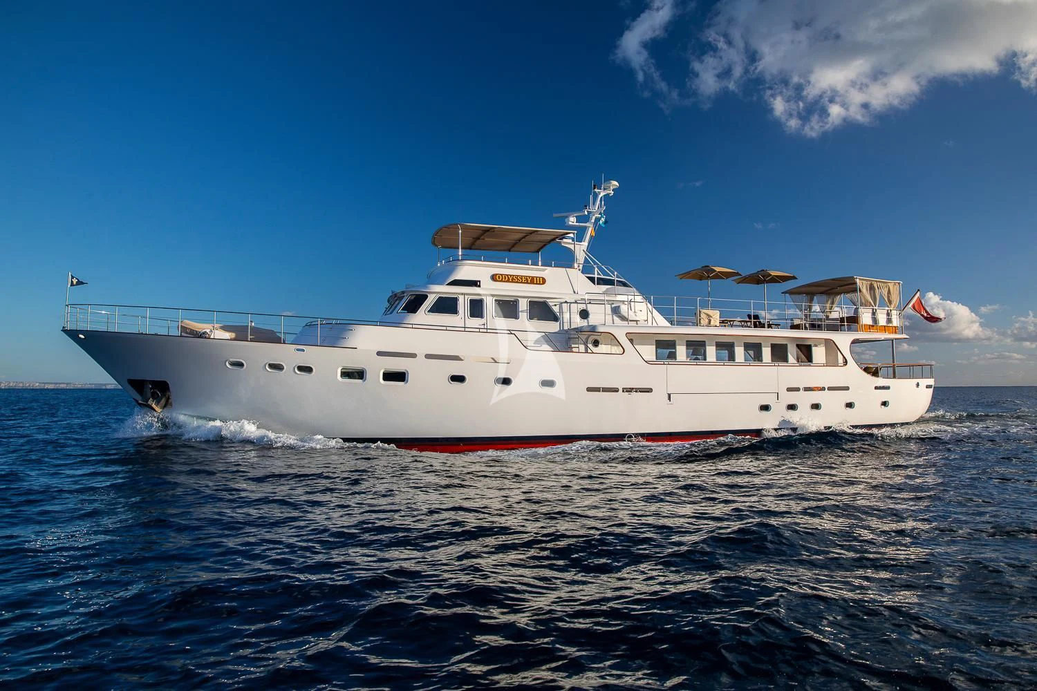 a white boat on the water aboard ODYSSEY III Yacht for Sale