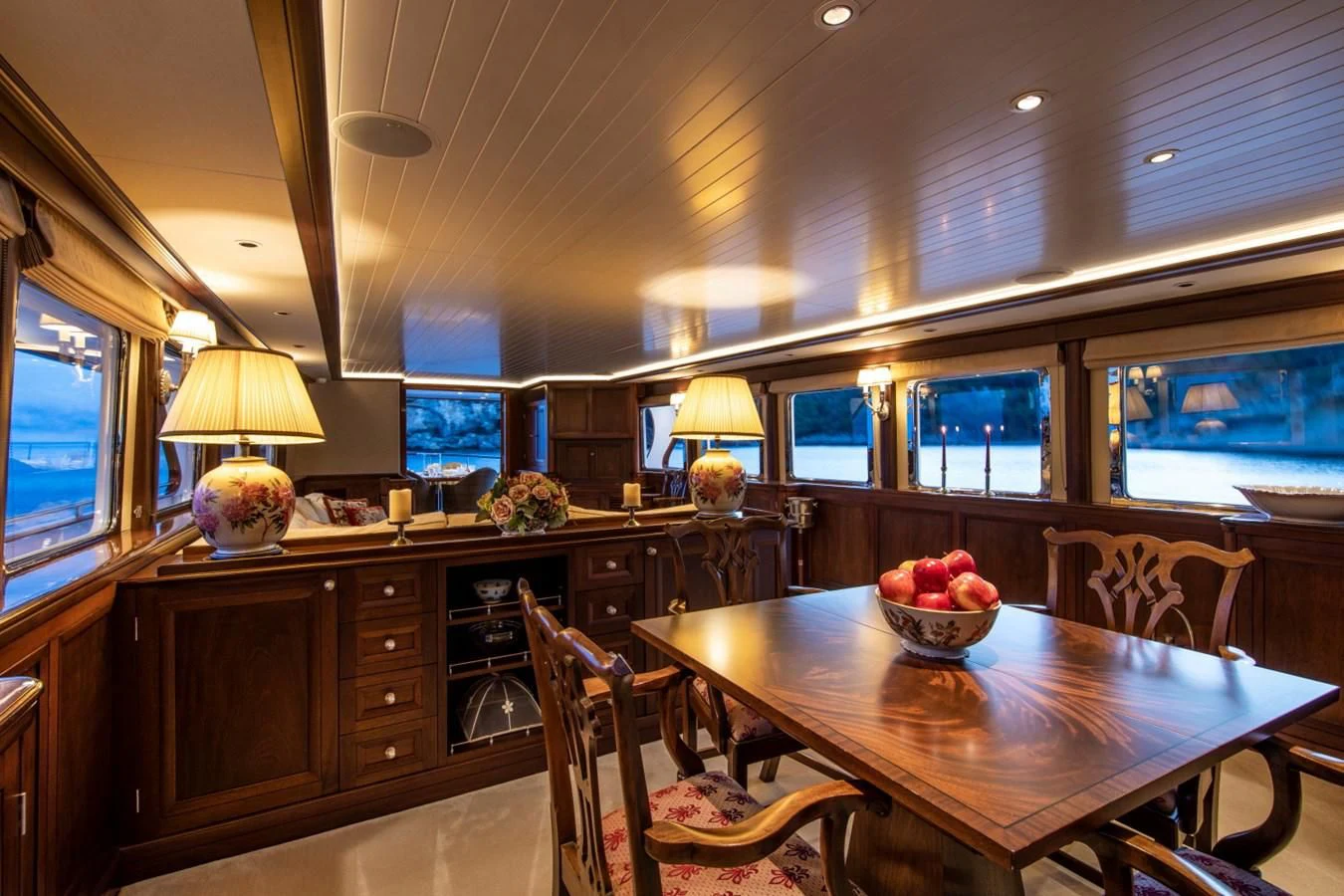 a kitchen with a table and chairs aboard ODYSSEY III Yacht for Sale