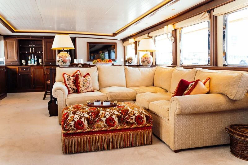 a living room with a couch and a table aboard ODYSSEY III Yacht for Sale