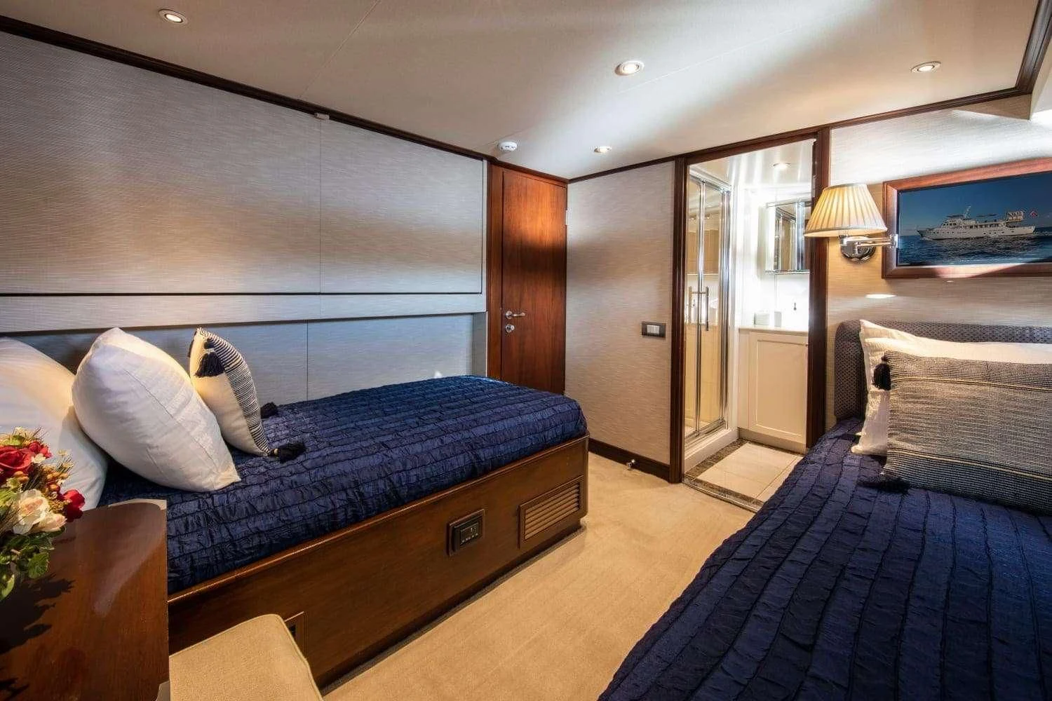 a bedroom with a bed and a television aboard ODYSSEY III Yacht for Sale