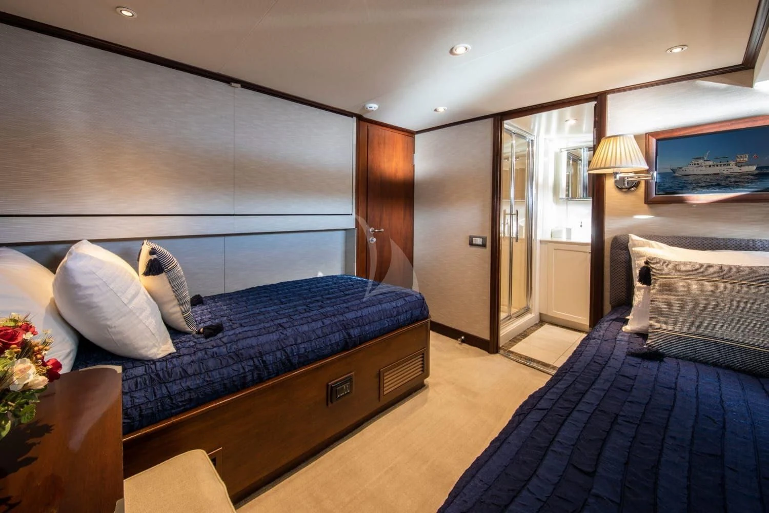 a bedroom with a bed and a television aboard ODYSSEY III Yacht for Sale