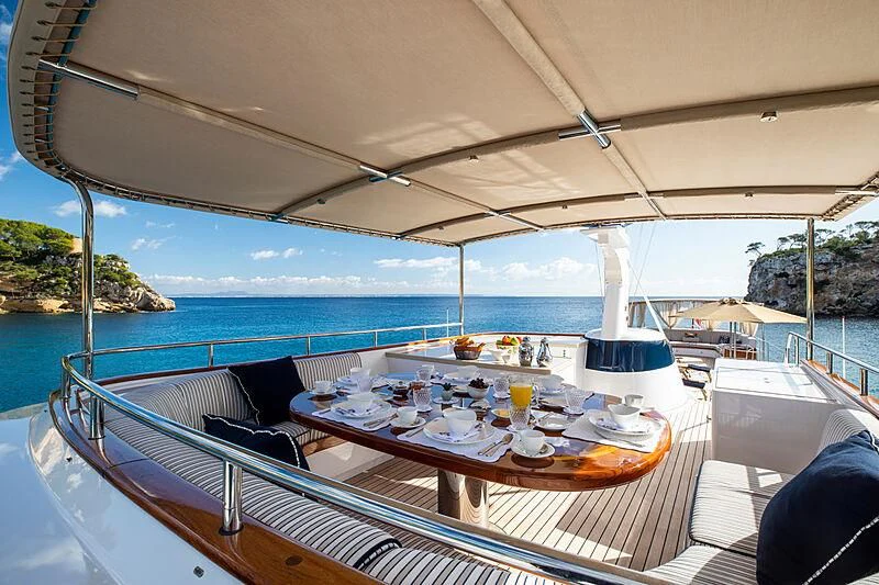 a table set for a meal on a boat aboard ODYSSEY III Yacht for Sale