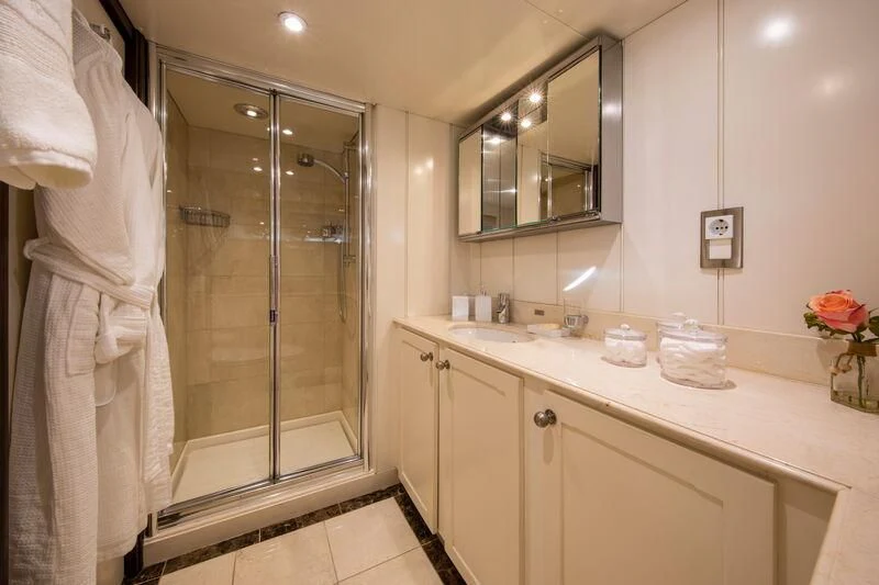 a bathroom with a glass shower aboard ODYSSEY III Yacht for Sale