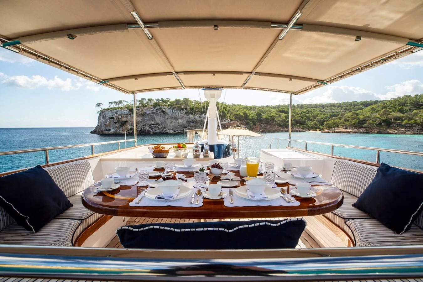 a table set for a meal on a boat aboard ODYSSEY III Yacht for Sale