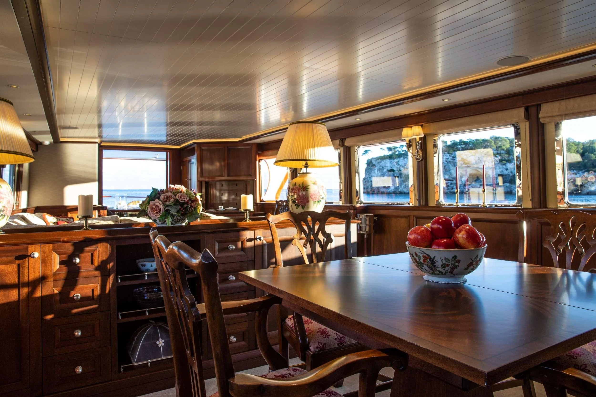 a kitchen with a large table and chairs aboard ODYSSEY III Yacht for Sale