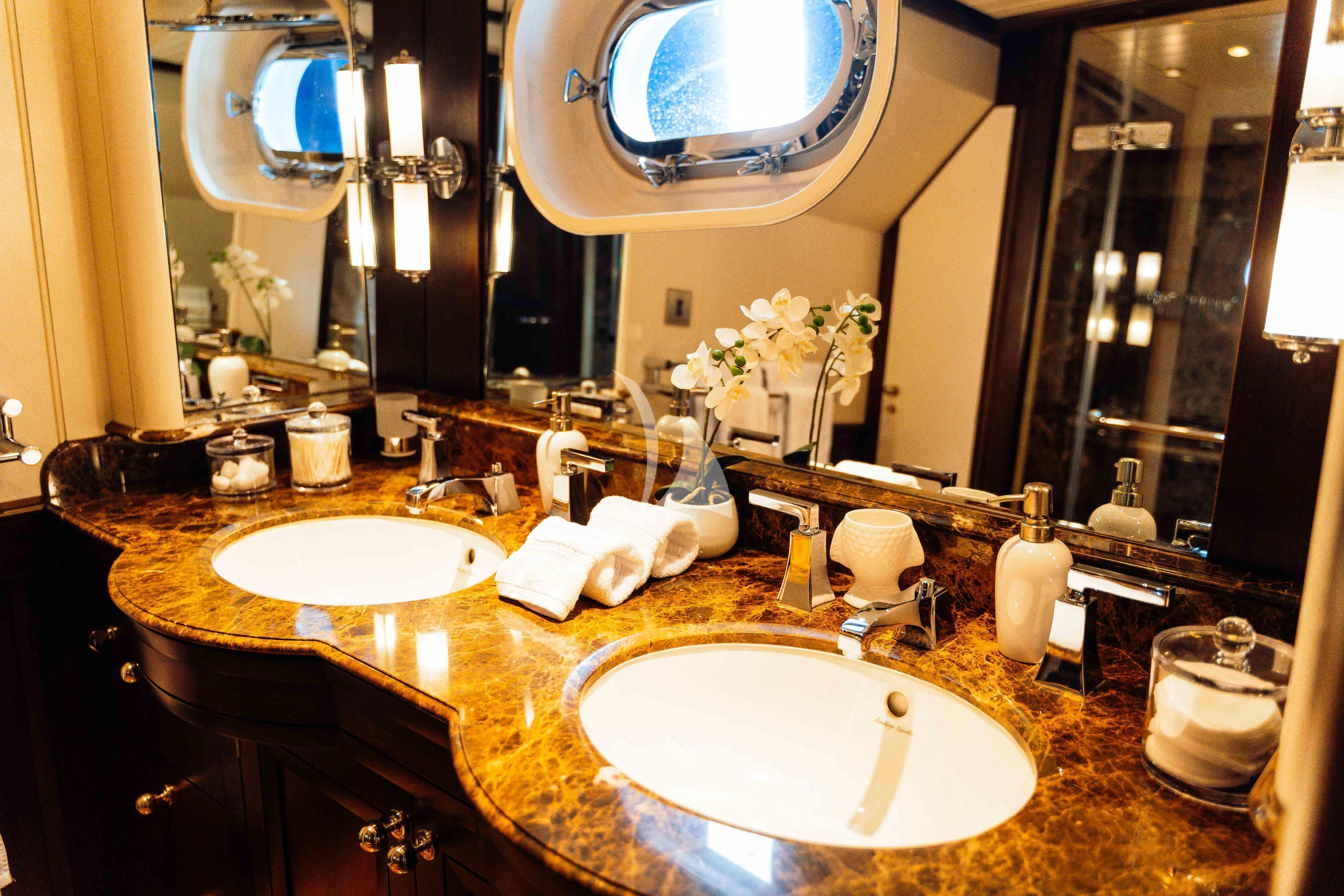 a bathroom with a large mirror aboard ODYSSEY III Yacht for Sale