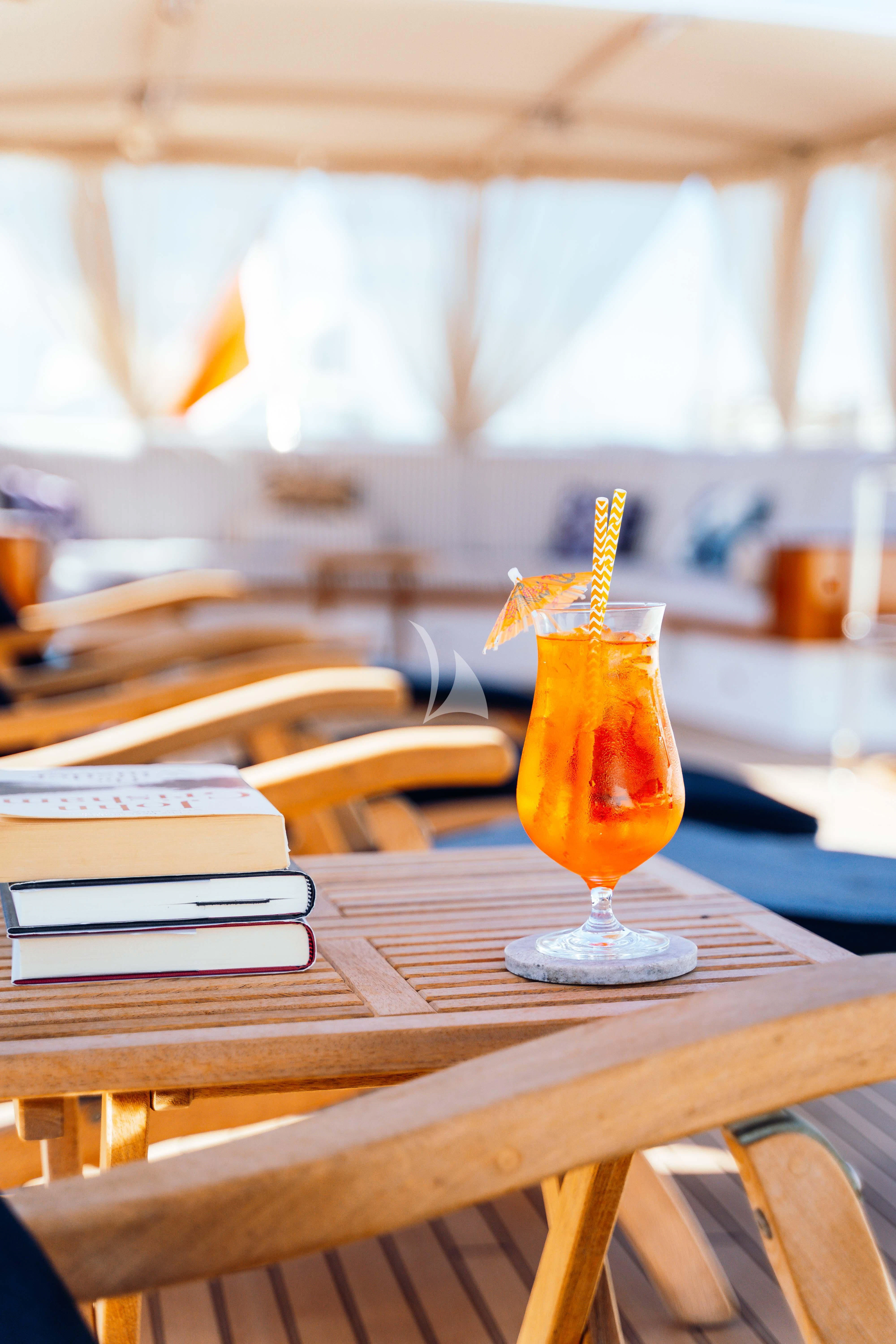a glass of liquid on a table aboard ODYSSEY III Yacht for Sale
