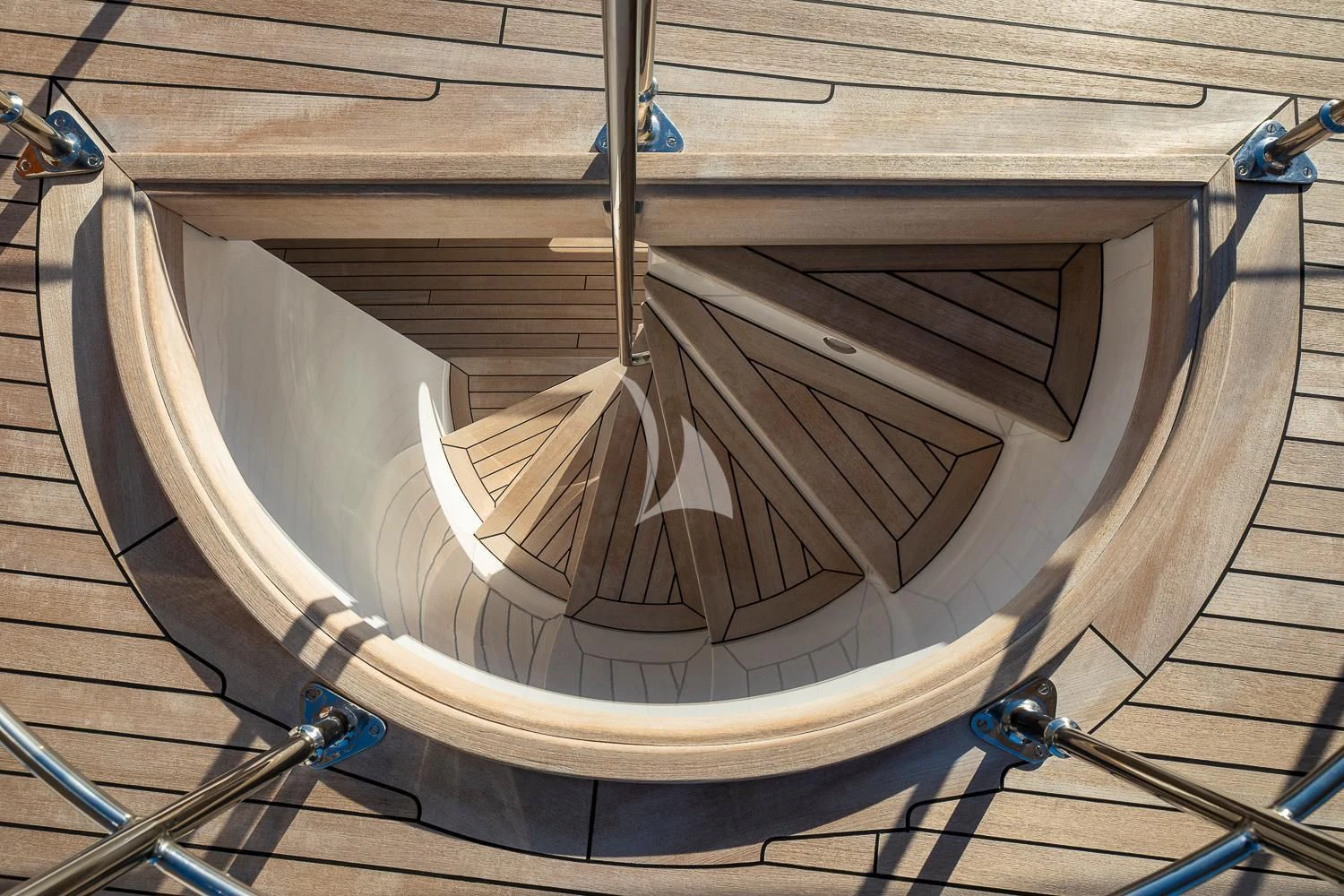 a white boat on a wooden deck aboard ODYSSEY III Yacht for Sale
