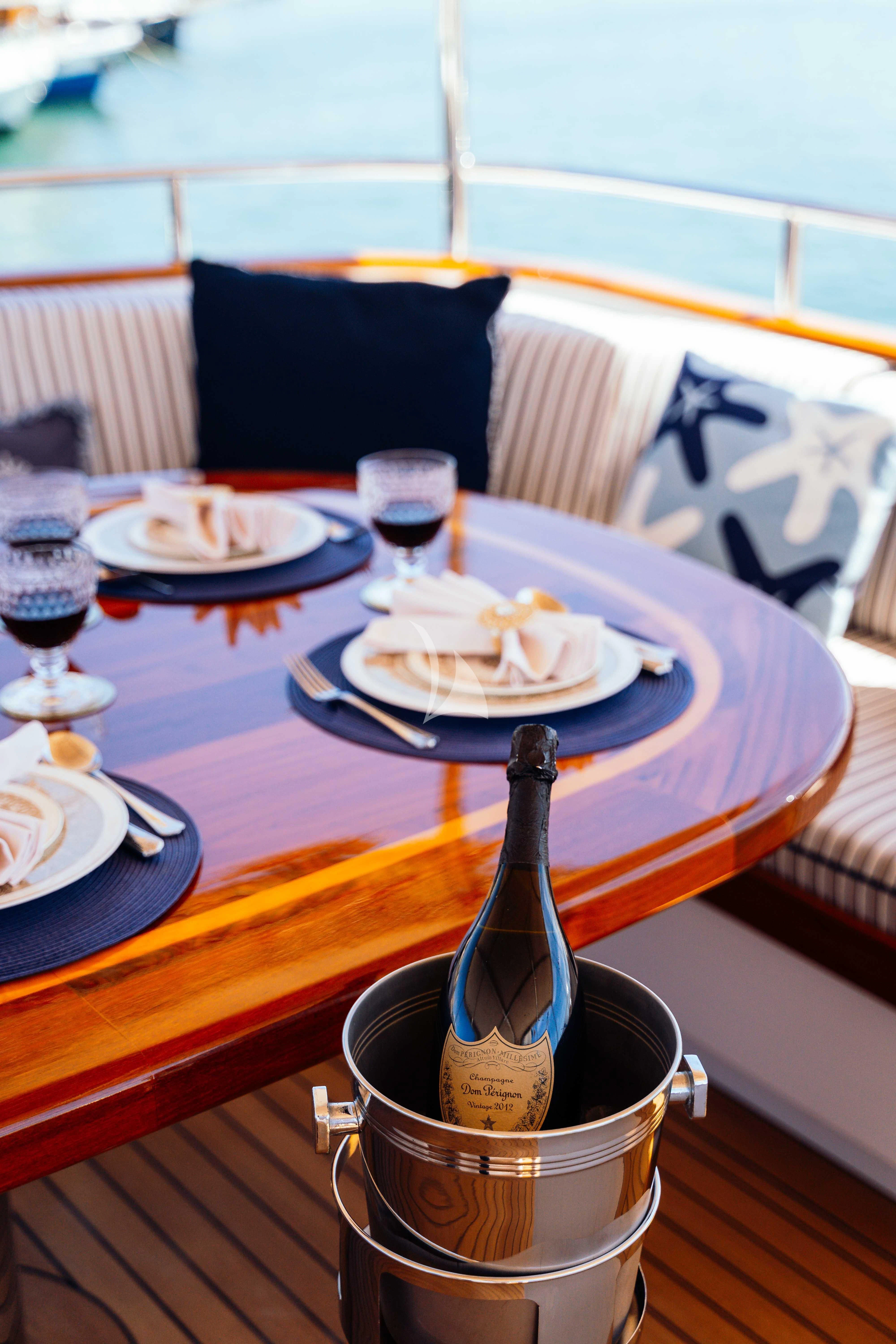 a table with plates and glasses on it aboard ODYSSEY III Yacht for Sale