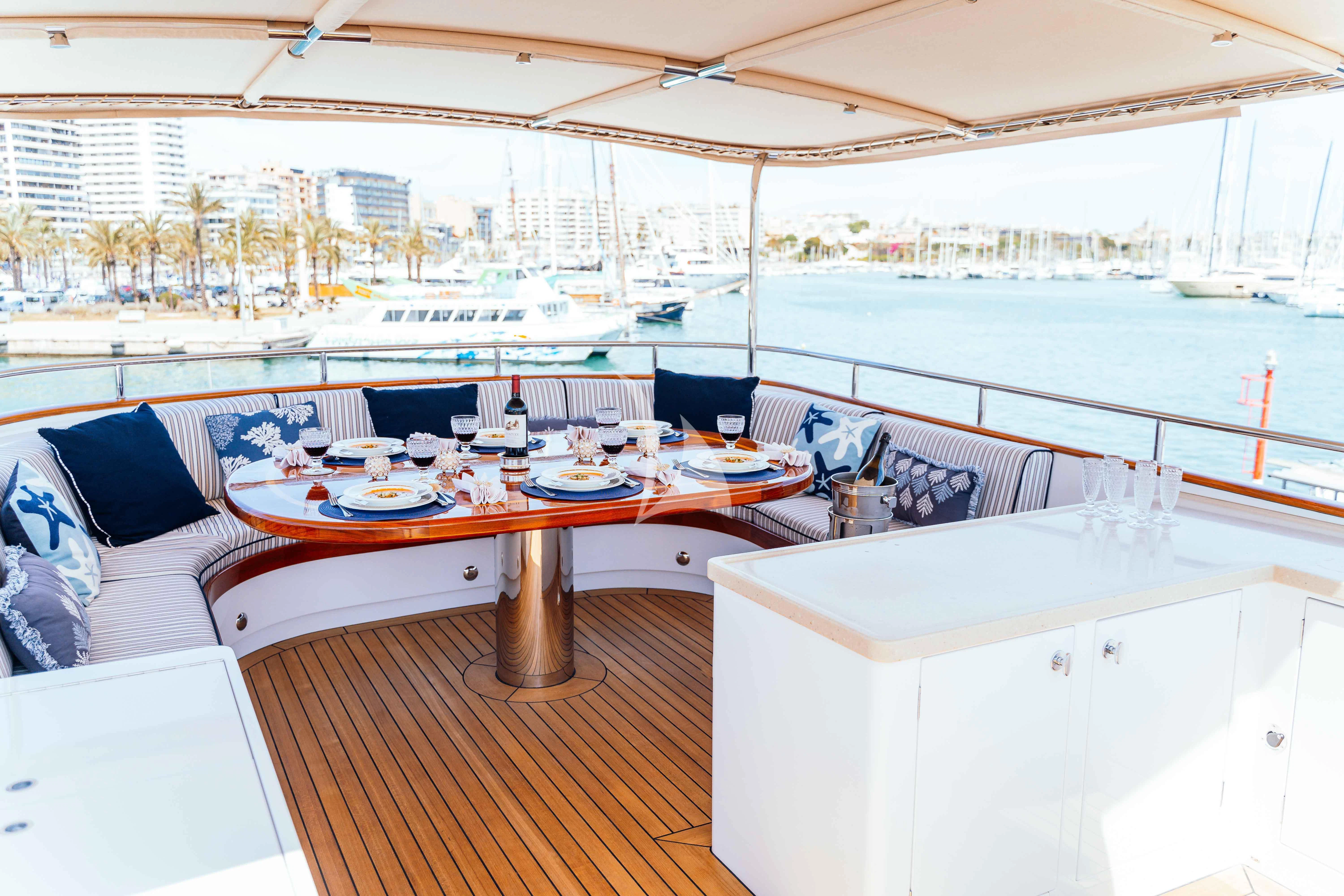 a table with plates and cups on it aboard ODYSSEY III Yacht for Sale