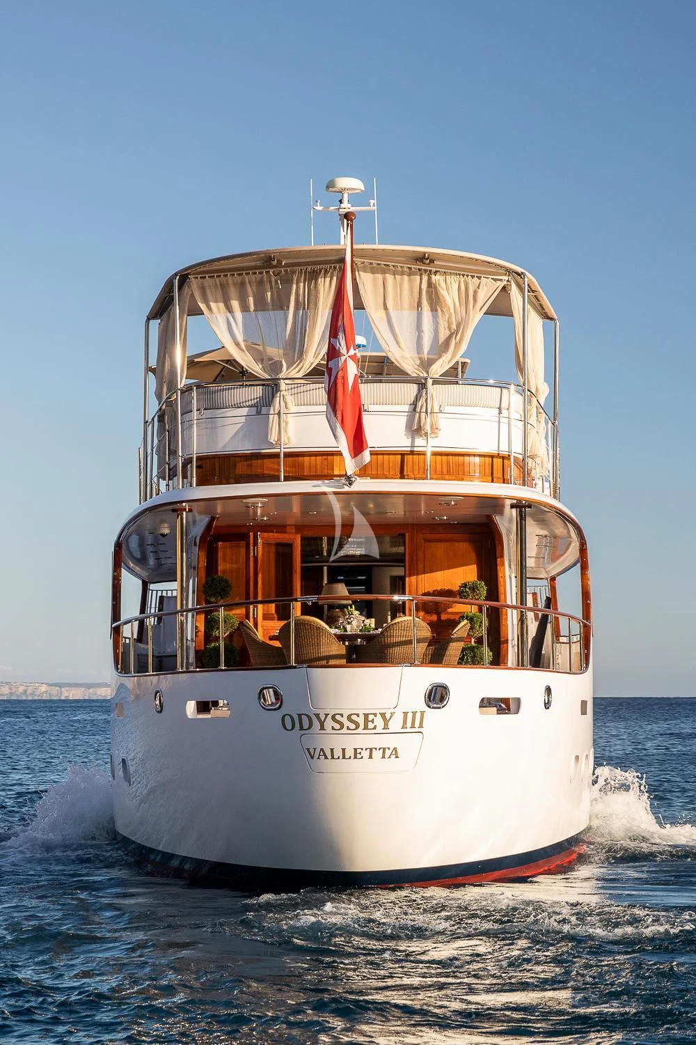 a boat with a flag on the front aboard ODYSSEY III Yacht for Sale