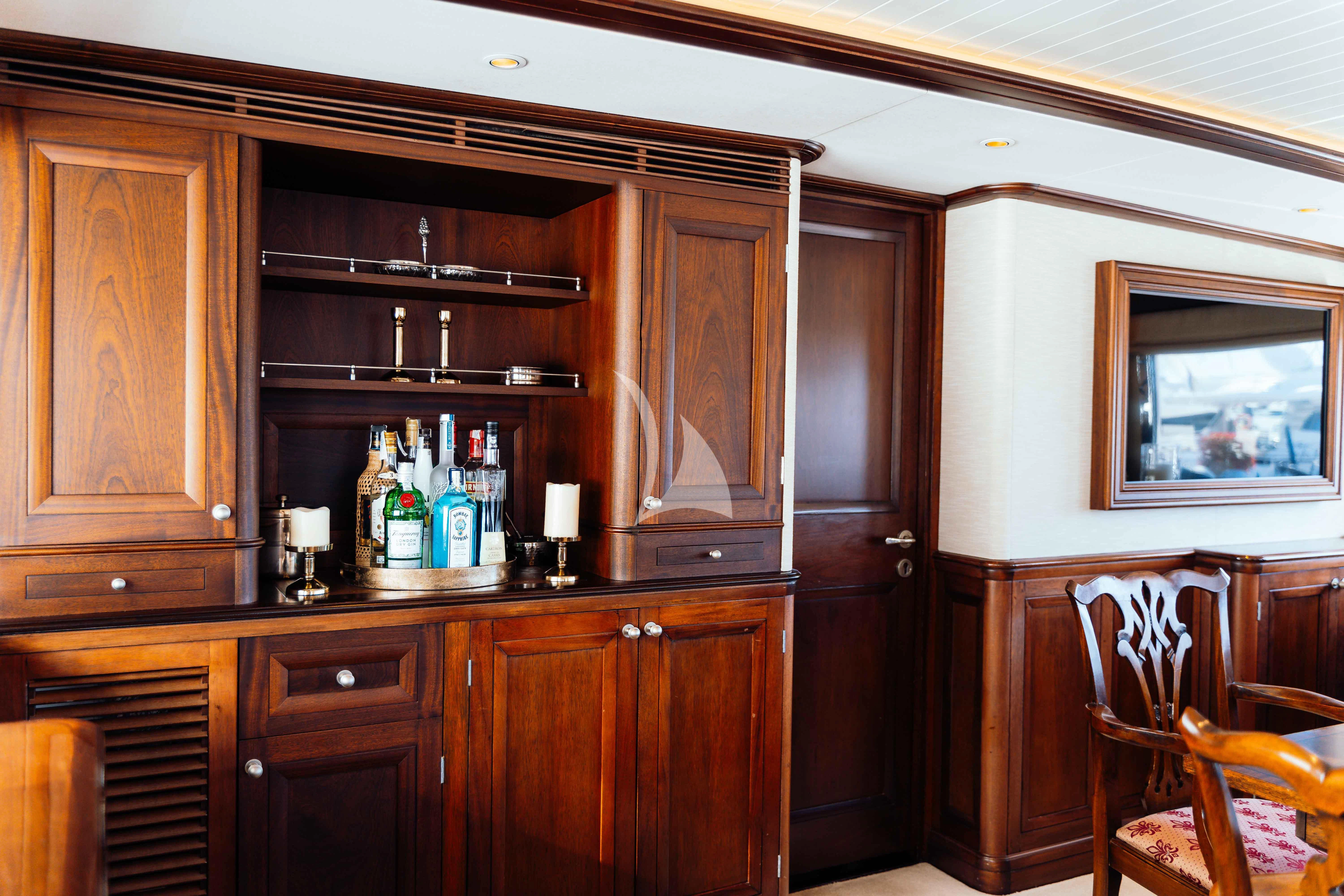 a kitchen with wooden cabinets aboard ODYSSEY III Yacht for Sale