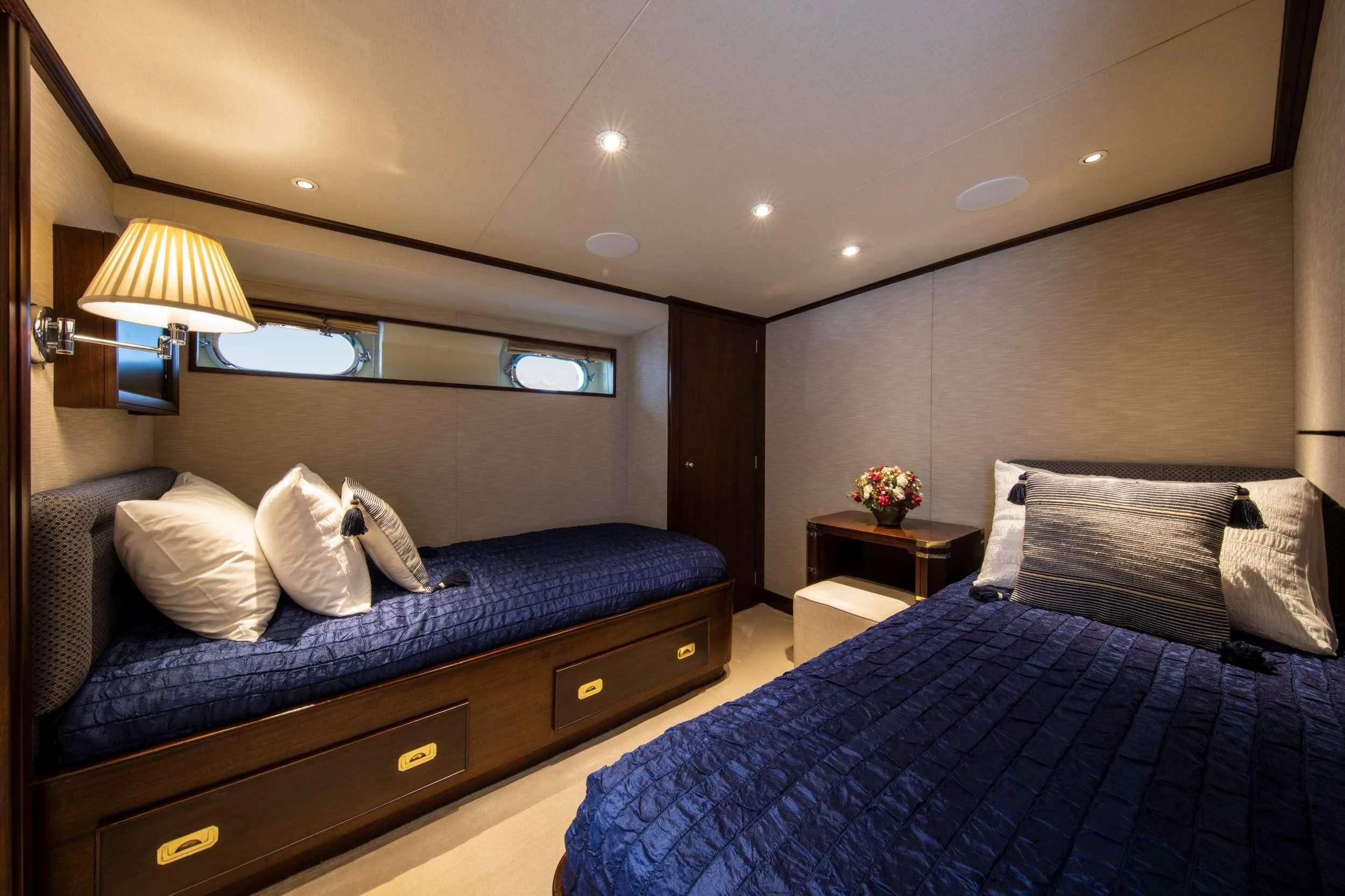 a bedroom with a bed and a desk aboard ODYSSEY III Yacht for Sale