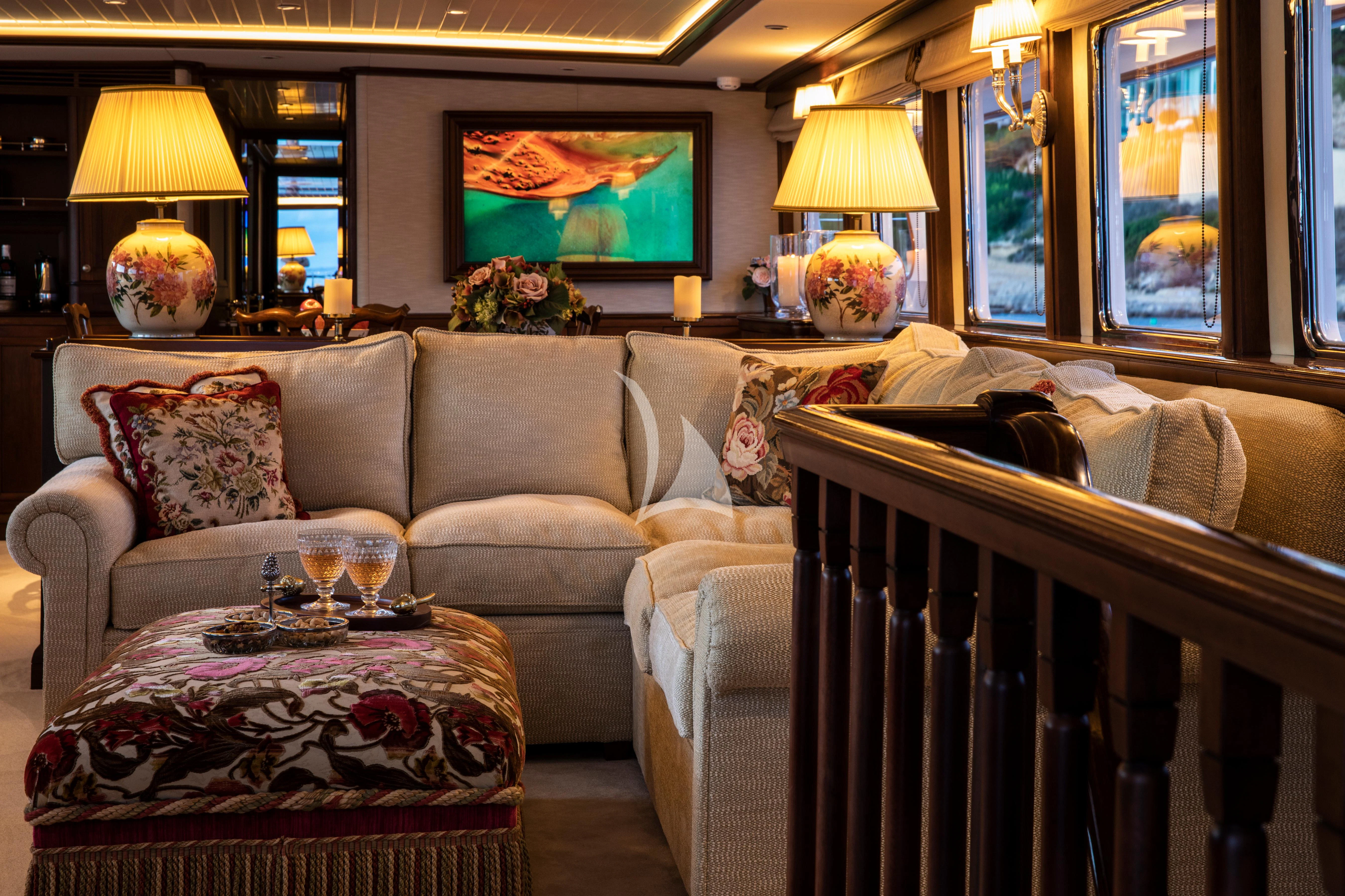 a living room with a couch and a table aboard ODYSSEY III Yacht for Sale