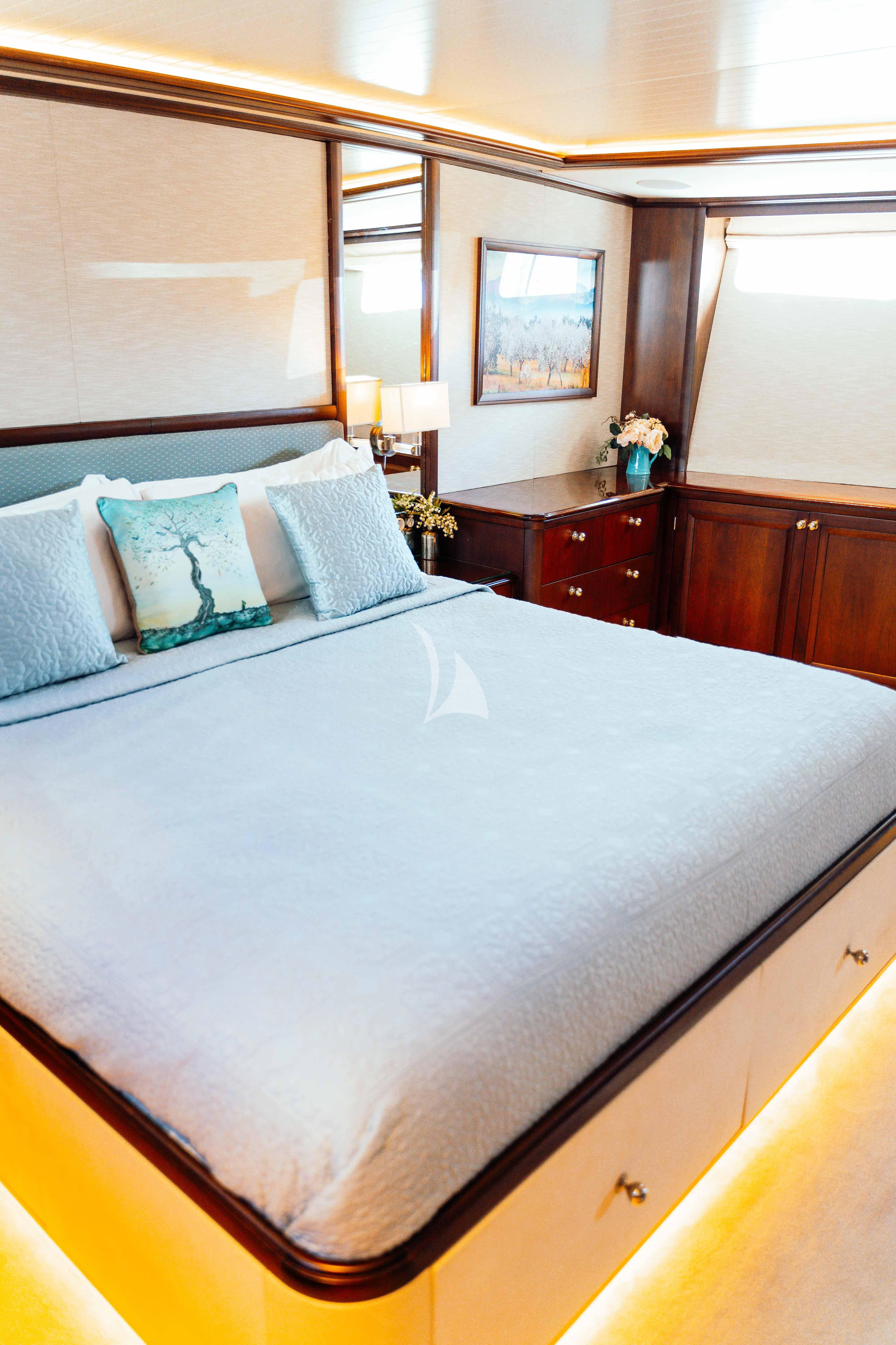 a bed with white sheets and pillows aboard ODYSSEY III Yacht for Sale