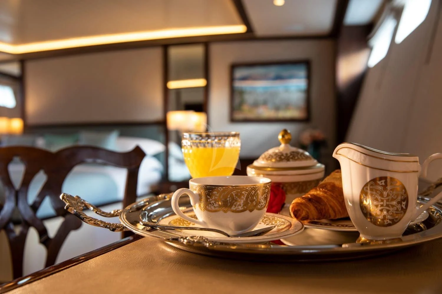 a table with tea cups and saucers on it aboard ODYSSEY III Yacht for Sale