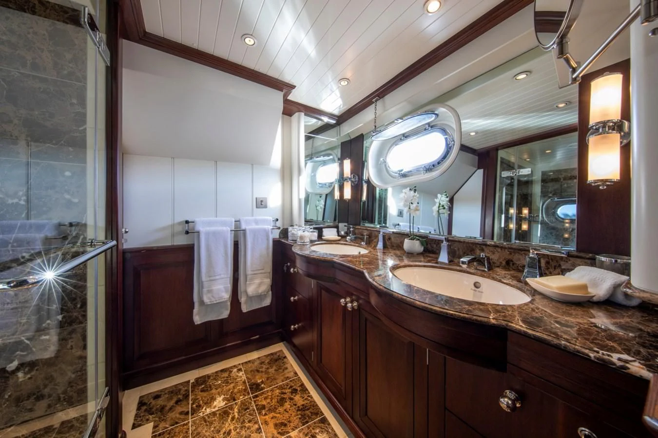 a bathroom with a large mirror aboard ODYSSEY III Yacht for Sale