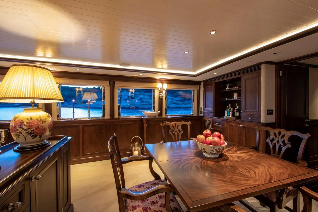 a kitchen with a table and chairs aboard ODYSSEY III Yacht for Sale