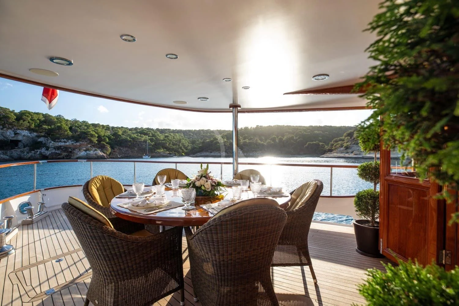 a table and chairs on a patio aboard ODYSSEY III Yacht for Sale