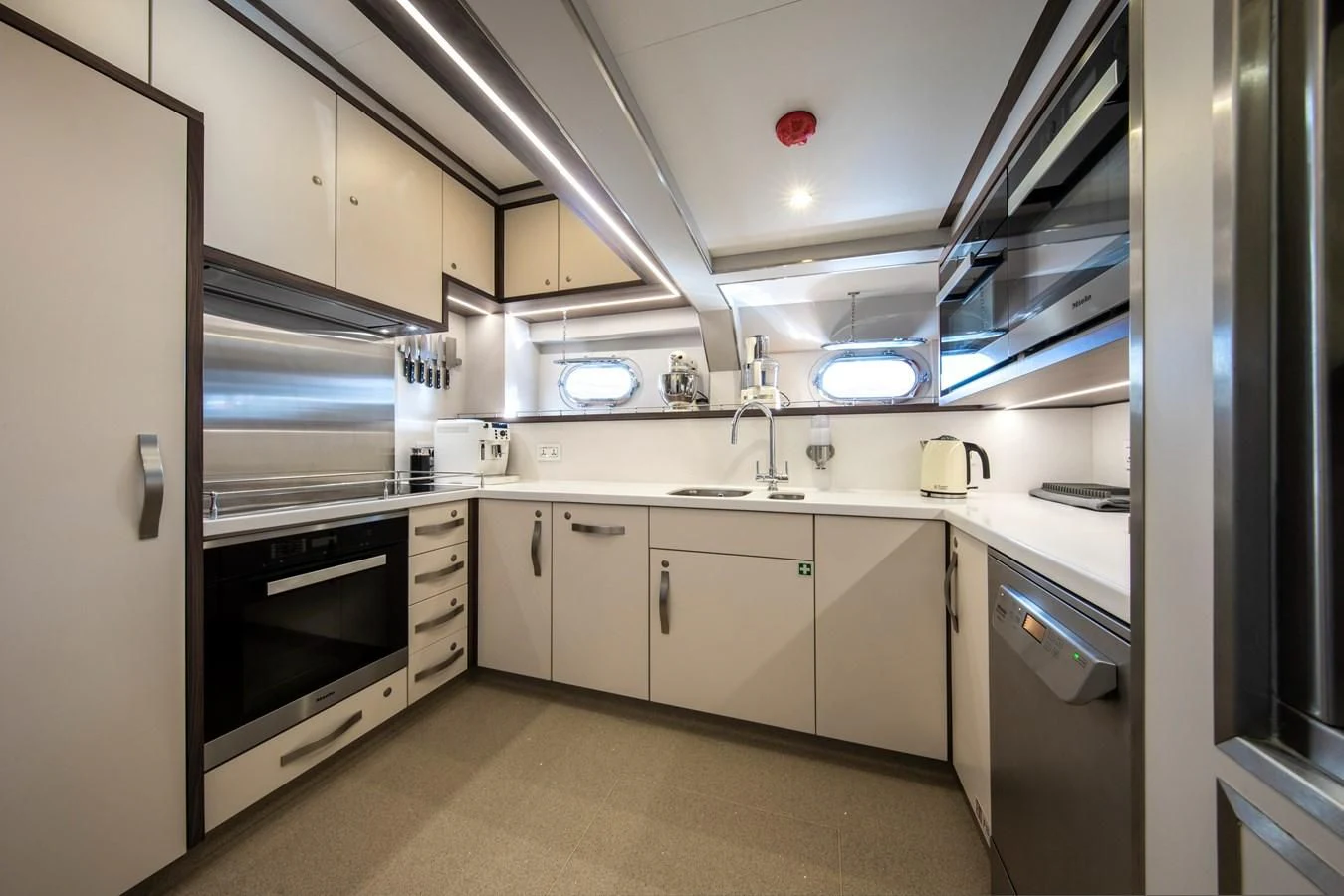 a kitchen with white cabinets aboard ODYSSEY III Yacht for Sale