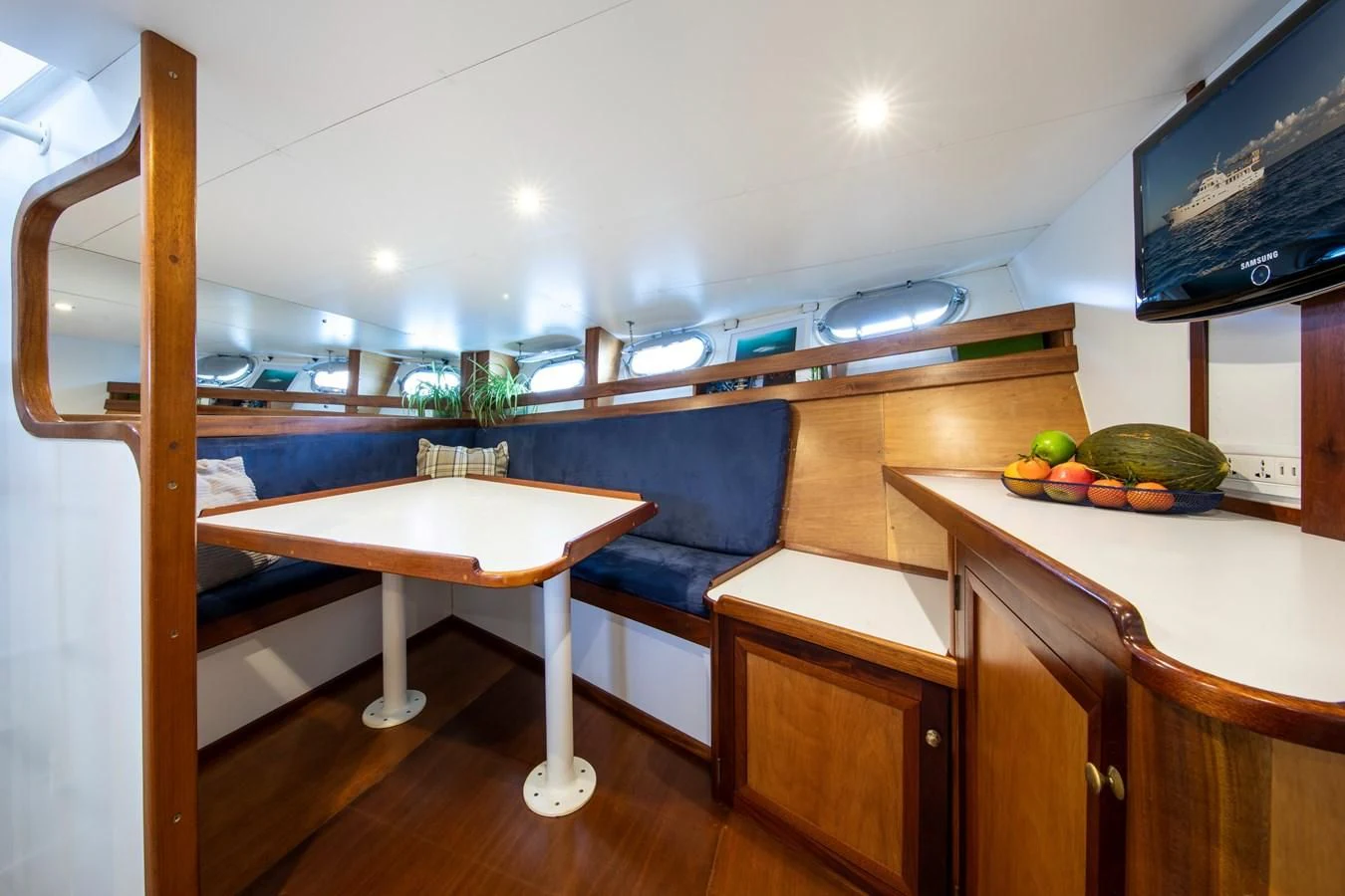 a kitchen with a table and chairs aboard ODYSSEY III Yacht for Sale
