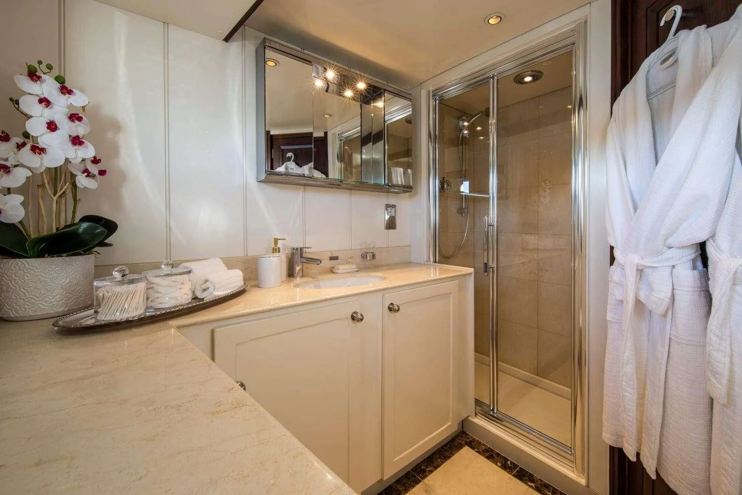 a bathroom with a glass shower aboard ODYSSEY III Yacht for Sale