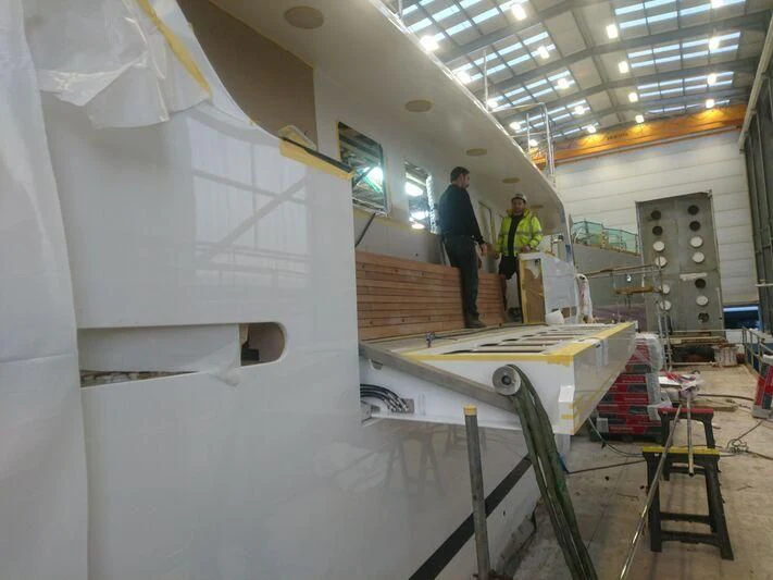 a few men working on a project aboard ODYSSEY III Yacht for Sale