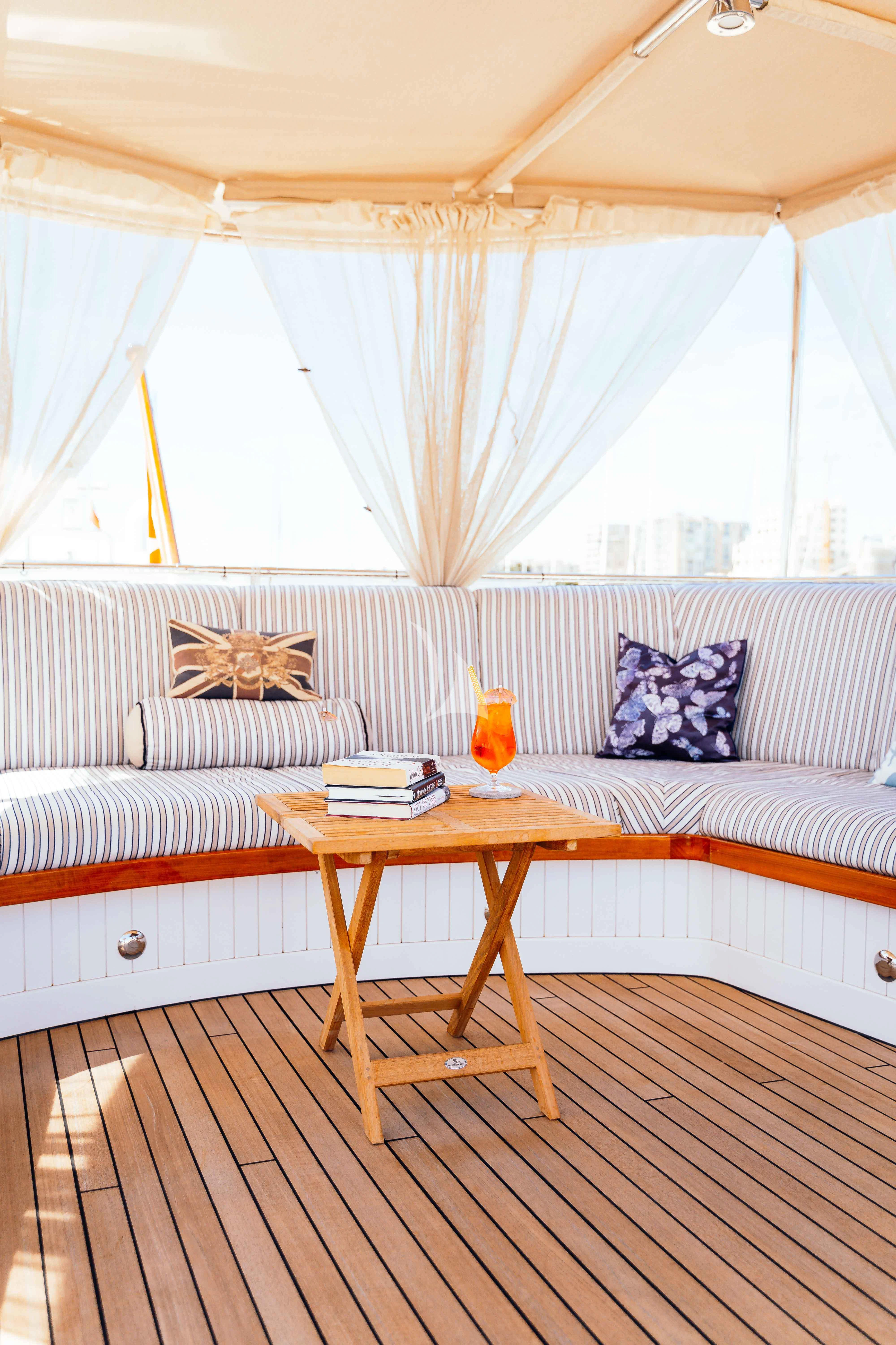 a bed with a table and a bed aboard ODYSSEY III Yacht for Sale