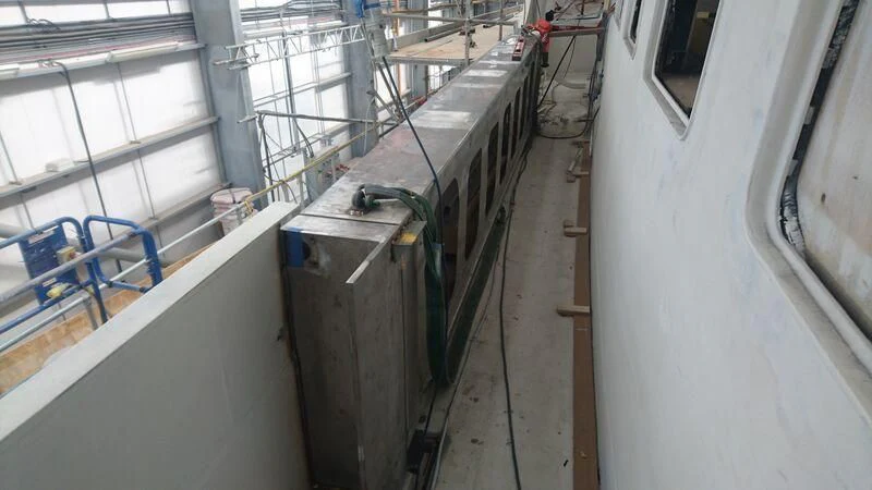 a large room with a large metal object on the floor aboard ODYSSEY III Yacht for Sale