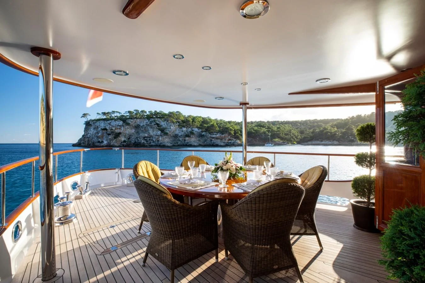 a table and chairs on a deck aboard ODYSSEY III Yacht for Sale