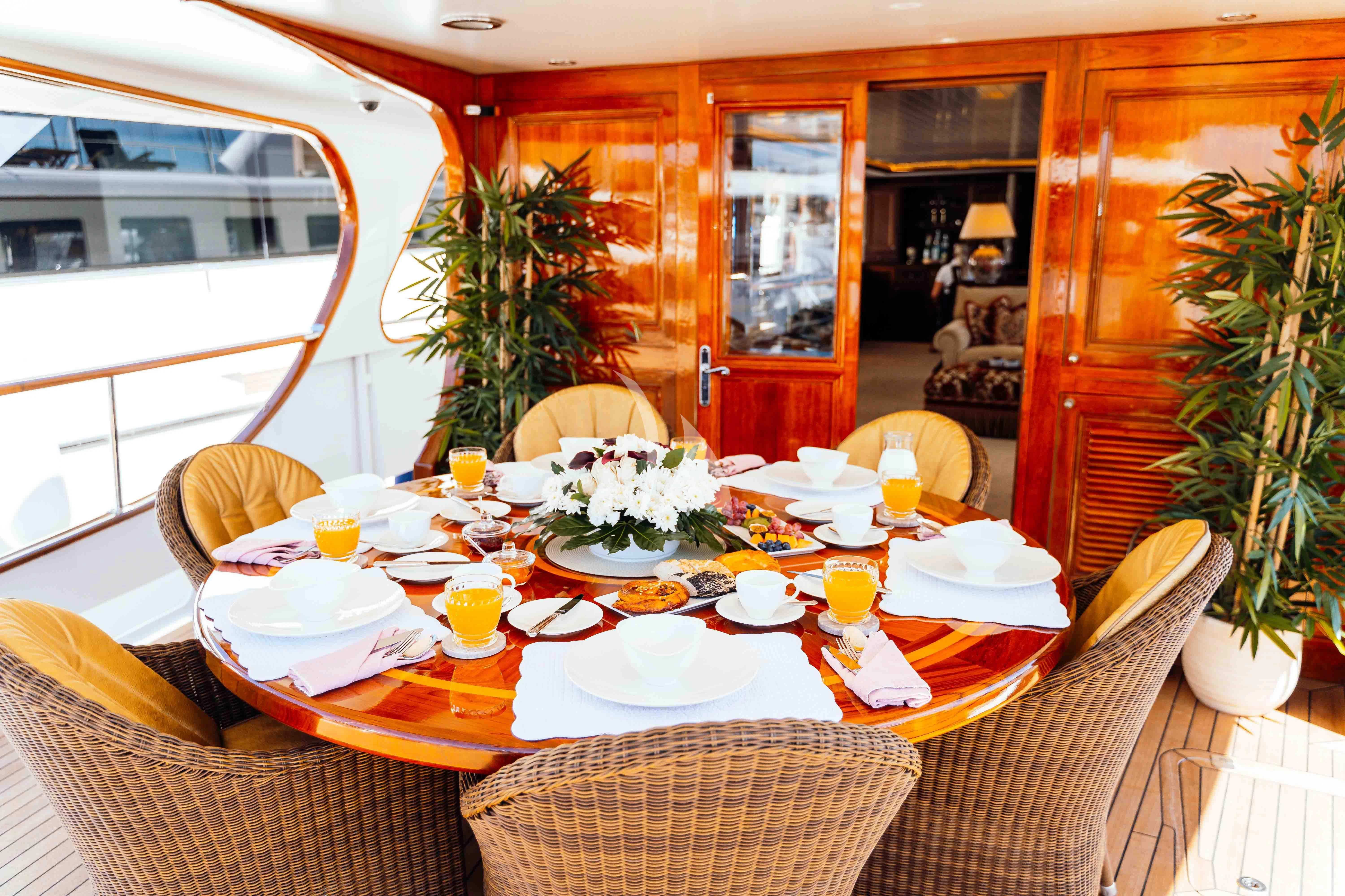 a table set with plates and food aboard ODYSSEY III Yacht for Sale