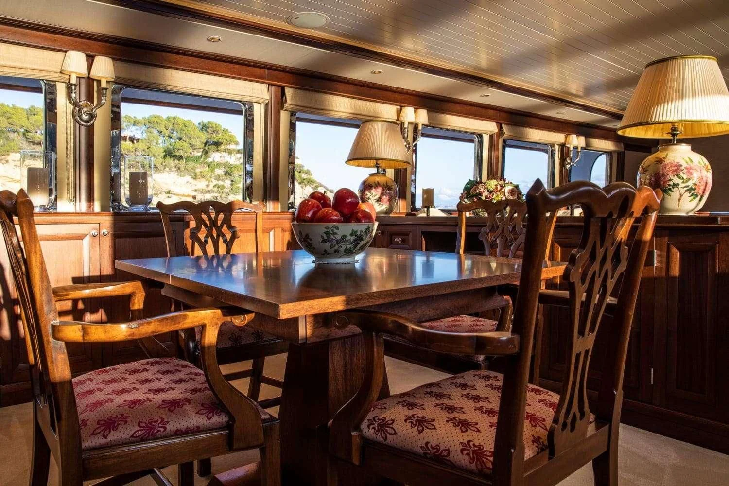 a dining room with a table and chairs aboard ODYSSEY III Yacht for Sale