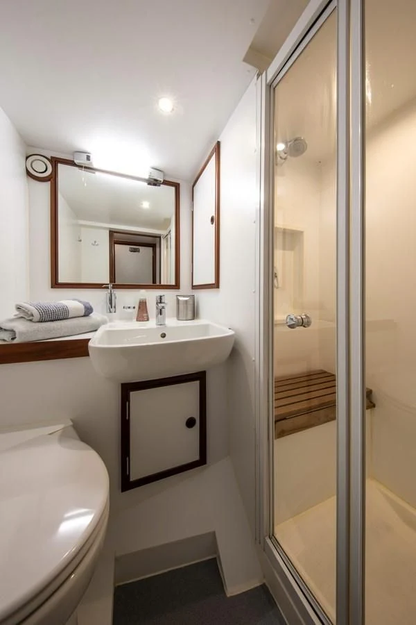 a bathroom with a sink and a shower aboard ODYSSEY III Yacht for Sale