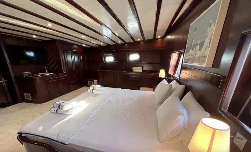 a large bed in a room aboard ALWAYS SMILE Yacht for Charter