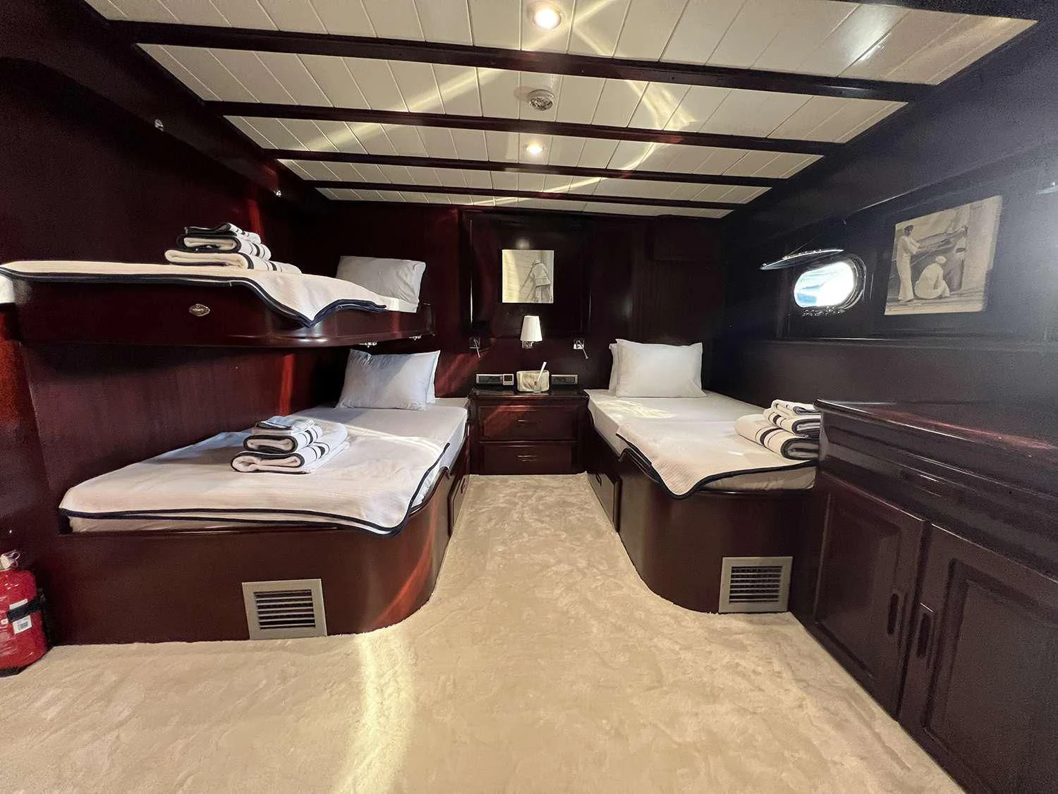 a room with beds and a tv aboard ALWAYS SMILE Yacht for Charter