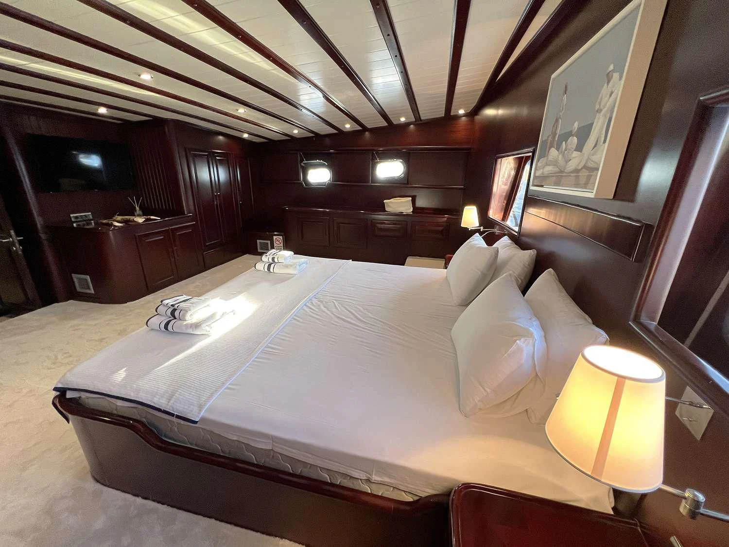a large bed in a room aboard ALWAYS SMILE Yacht for Charter