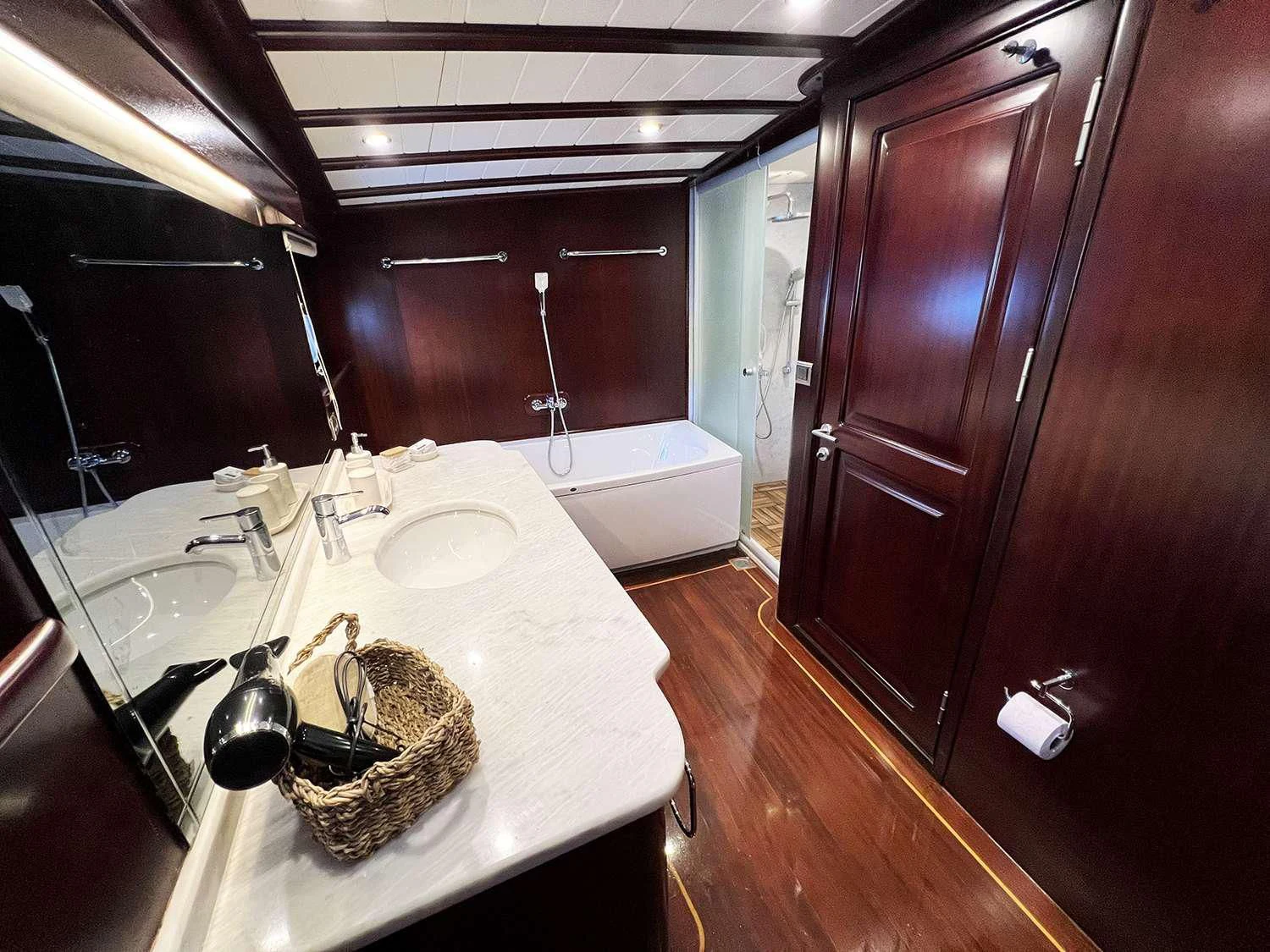 a bathroom with a sink and a bathtub aboard ALWAYS SMILE Yacht for Charter