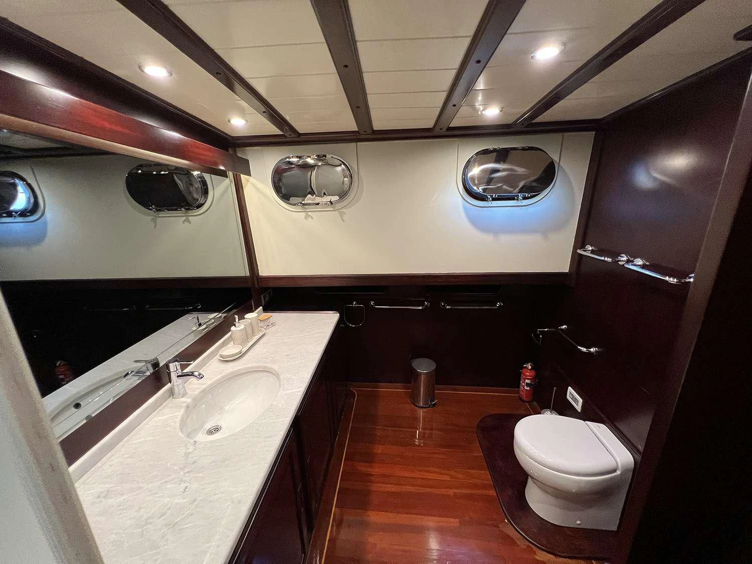 a bathroom with a large oval mirror aboard ALWAYS SMILE Yacht for Charter
